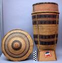 Cylindrical rattan basket with cover. 10 3/4" diam. Twill, wickerwork