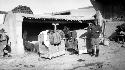 Woman standing by camel carriers