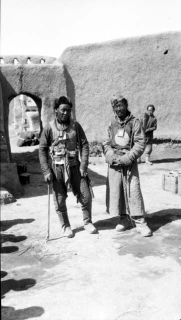 People standing by doorway in wall