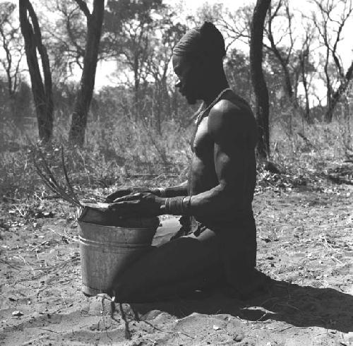 Bela playing a //guashi on a tin bucket