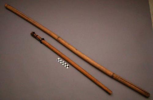 Unclassified tool, two bamboo poles, perforated, cracked, resin applied to one