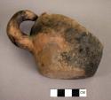 Fragment of mug with one loop handle. San Bernardino yellow