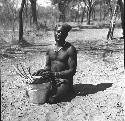 Bela playing a //guashi on a tin bucket