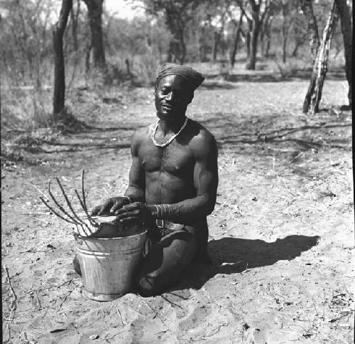 Bela playing a //guashi on a tin bucket