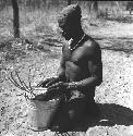 Bela playing a //guashi on a tin bucket