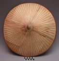 Hat, conical (shallow) of natural wood strips secured by fibers. +