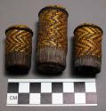 Plugs, cylindrical rolled fiber covered with yellow and brown woven basketry