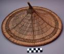 Conical hat of palm leaves, strung together