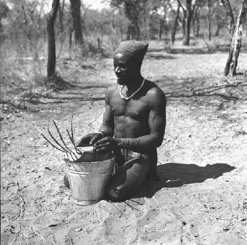 Bela playing a //guashi on a tin bucket