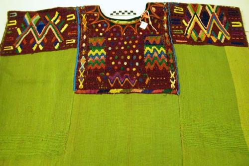 Green huipil with geometric designs