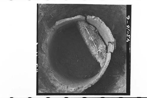 Top of broken, large pottery vessels in pot hole 11