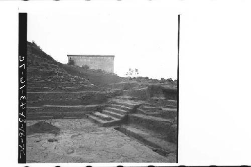 Progress of work photo of N. side of central structure and plaza as found.  Brok