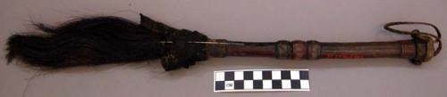 Cow's tail with poisoned needle