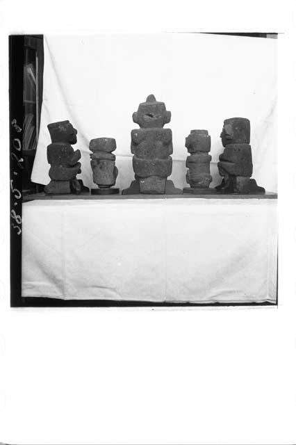 Five small stone figures (back)