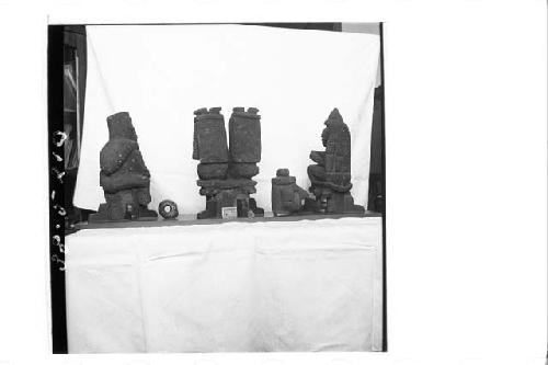 4 small stone figures (back); 1 small stone head (back); 1 small stone ring (b