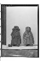 Two pottery figures with snouted heads & long oblong shields