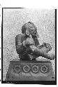 Large pottery figure seated cross-legged with body scarified or tatooed