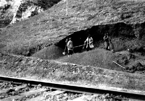 Men working beside railroad tracks