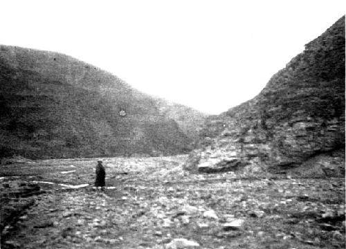 Person walking toward rocky pass