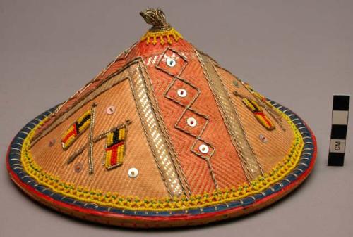 Conical hat with bright orange and blue interior, exterior shows fine woven cane