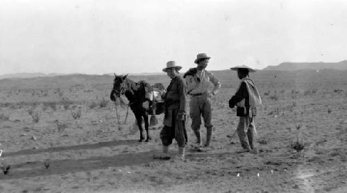 Men and pony in desert