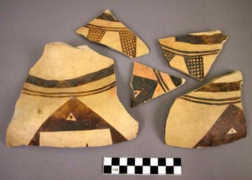 Fragments of black on yellow pottery jar