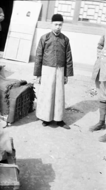 Young man standing outside of building