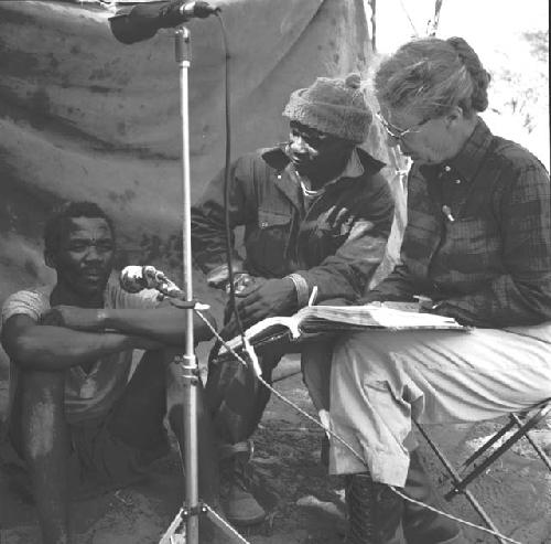 Man giving Kernel Ledimo (center) and Lorna Marshall a vocabulary list