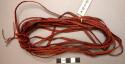 4-strand red braided belting worn by men around waist to hold up +