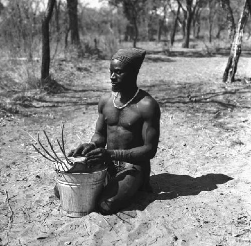 Bela playing a //guashi on a tin bucket