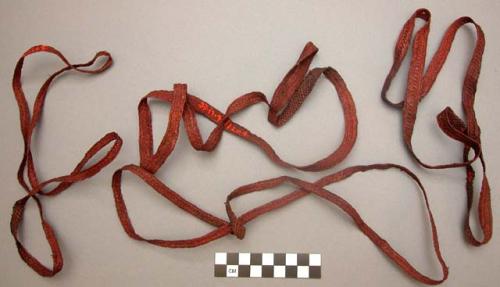 Red braided bandoliers ("ketip"), worn by men and women in dances, +