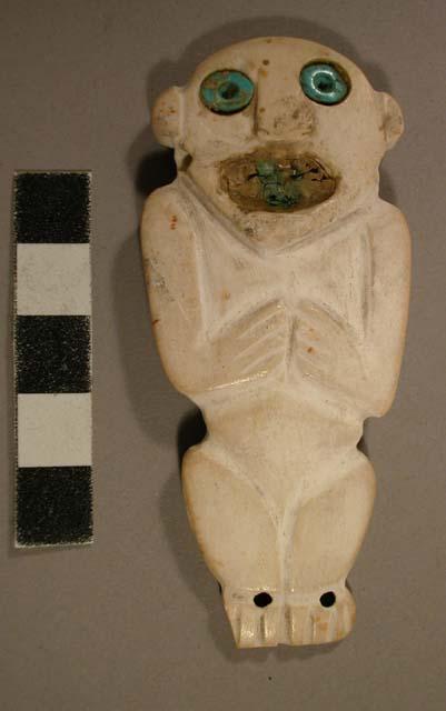 Shell ornament - human figure, turquoise eyes, gold mouth