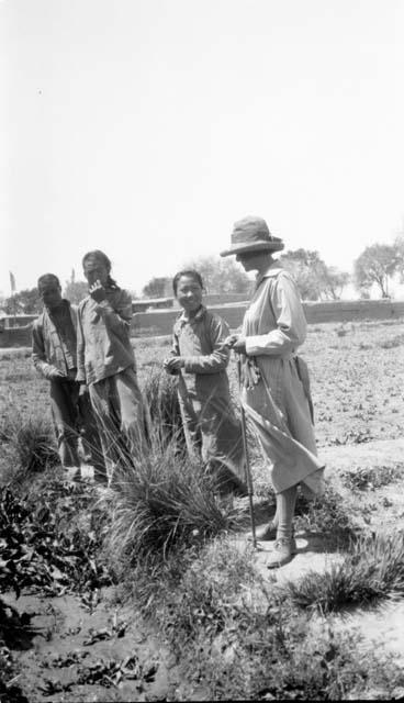 People standing by vegetation