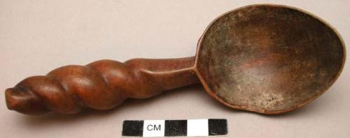 Spoon with twisted handle and inlaid seed