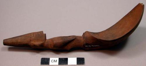 Wooden spoon, handle carved in human effigy: hands resting on flexed knees, turb