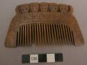 Wooden comb, incised and carved decoration of trophy heads