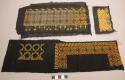Strips of black cloth with embroidered designs