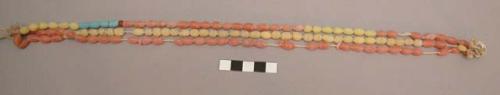 Pink, yellow, blue glass bead necklace, worn by women during the +