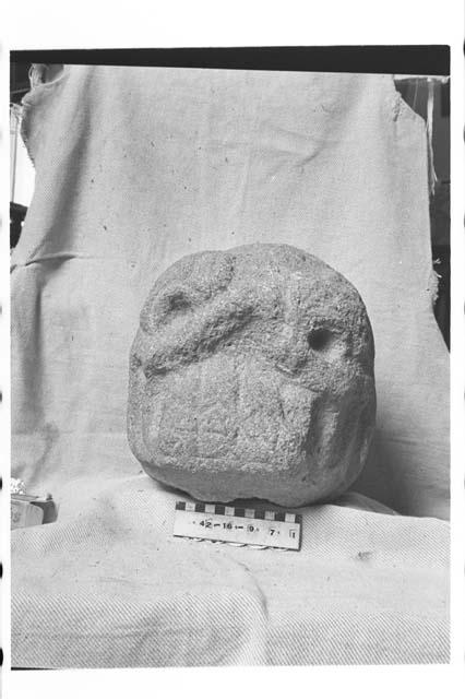 Carved stone head, broken from larger figure