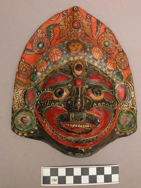 Papier mache mask - face painted black with polychrome design +