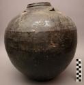 Jar, ceramic, dark brown glaze, flat base, round body, constricted rim, four lug