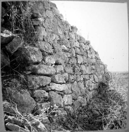 Terrace wall with plaster showing, West side of main pyramid - from Northwest.