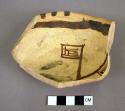 Fragment of black on yellow pottery bowl or ladle