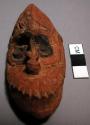 Tiny carved wooden mask - worked by child; hung on basket