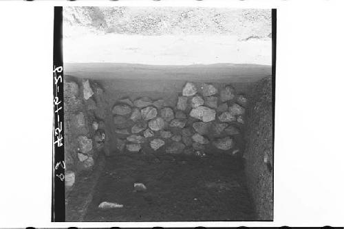 Layer of boulders in terrace fill covering base of battered E. terrace of Early