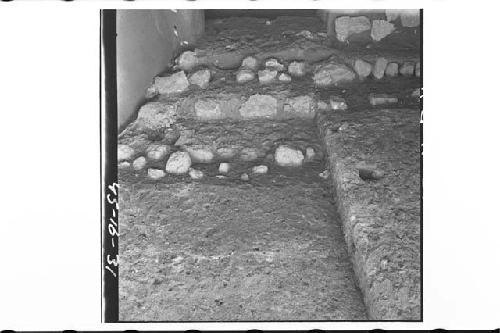 Lines of boulders in S. wall of trench. Base of Early platform in lower right. L