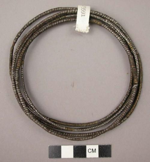 Leglets-circular piece of fibre wound with thin iron and brass stripes (ndiki)