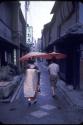 Kyoto -- Maiko and umbrella and modern girl