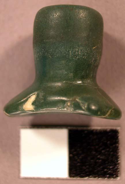 Flaked/ground nephrite labret. Head is oval, flared, & concave. Straight shaft.