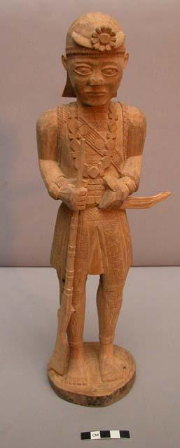 Wooden idol - man carrying gun & sword